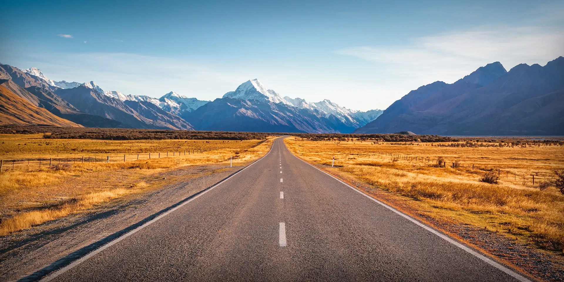 Straight road leading to mountains