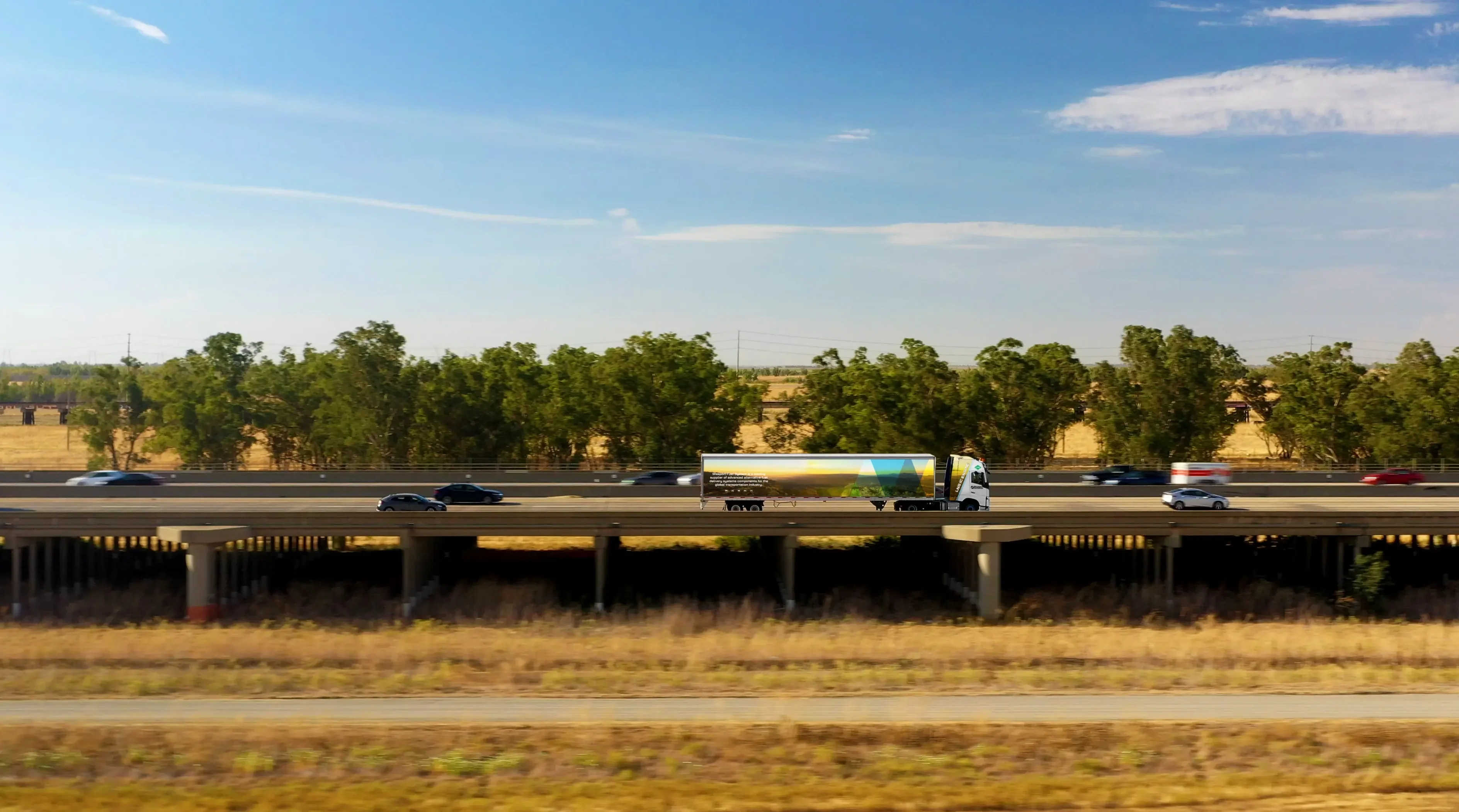 An image of a truck driving across a freeway.